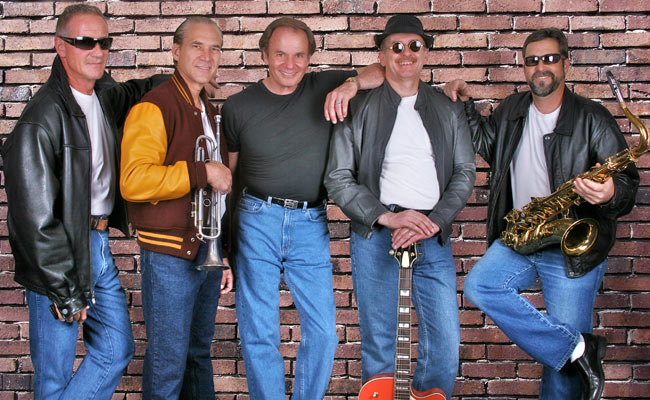 five male musicians dressed in sock hop attire