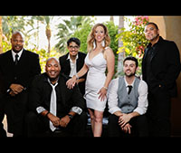6 musicians with female singer dressed in white