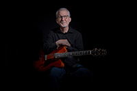 male musician posing with guitar