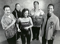 four latino musicians and female singer
