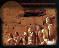 six male native american musicians with ruins in background