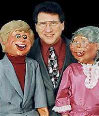 male ventriloquist with two puppets