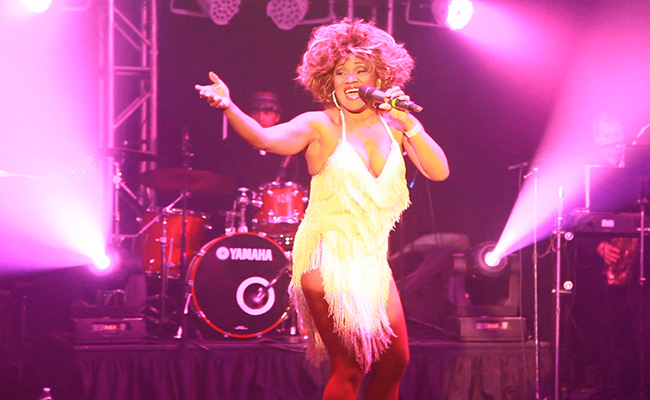Tina Turner impersonator singing with drums in background