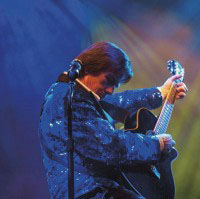 male showman in blue with guitar