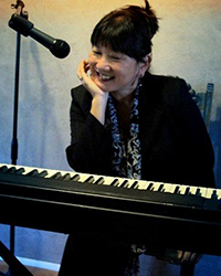 female pianist singer at keyboard
