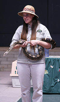 female trainer holding a snake