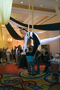 female aerialist in black white costume in silks